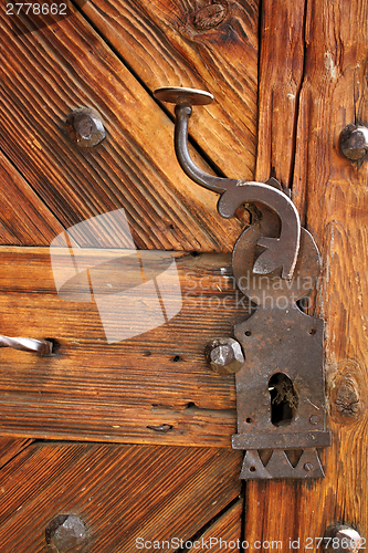 Image of ancient latch on beautiful wooden door