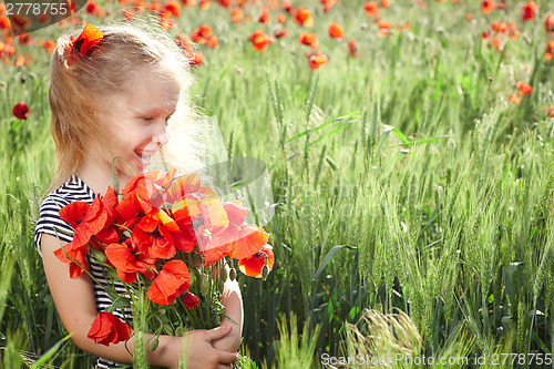 Image of Little girl on the poppy meadow with posy