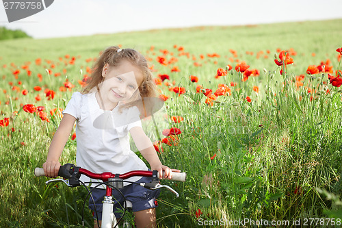 Image of Happy smiling little girl with bicycle