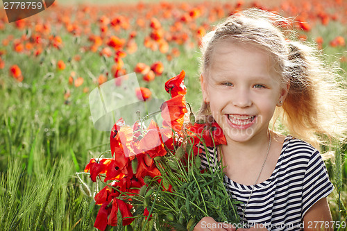 Image of Happy laughing little girl  on the poppy meadow