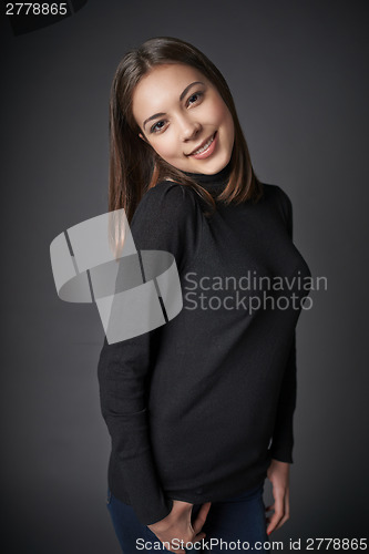 Image of Closeup portrait of smiling teen female in black pullover