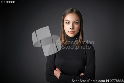 Image of Closeup portrait of young female in black pullover