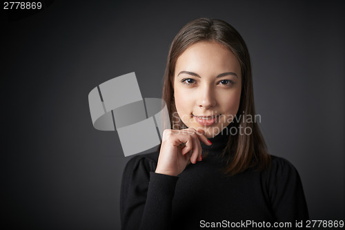 Image of Closeup portrait of smiling teen female in black pullover