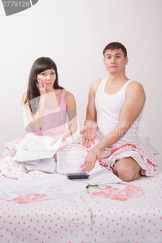 Image of Newlyweds very surprised total amount of invoices for payment