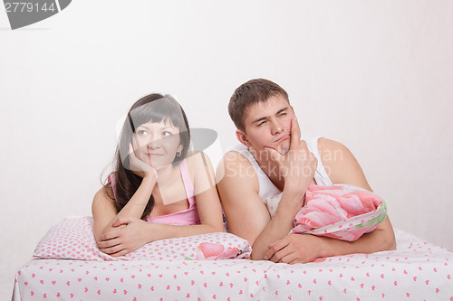 Image of Girl and guy lying in bed dreaming