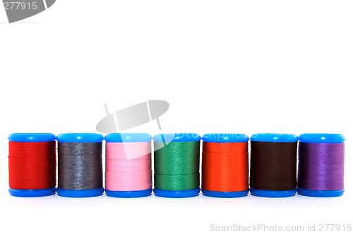 Image of Row of colorful thread spools