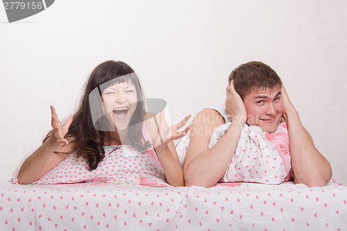 Image of Girl hysterical shouts strongly in bed