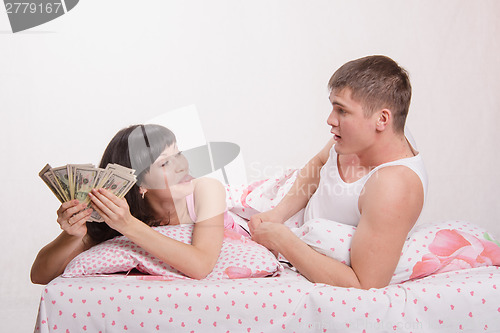 Image of Wife gives her husband money