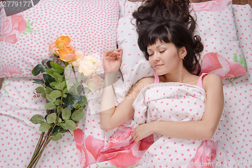 Image of Girl gave flowers in bed