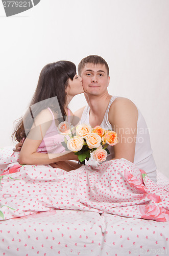 Image of Grateful for the donated flowers girl kissing guy