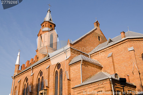 Image of gothic church with crosses on blue sky background 