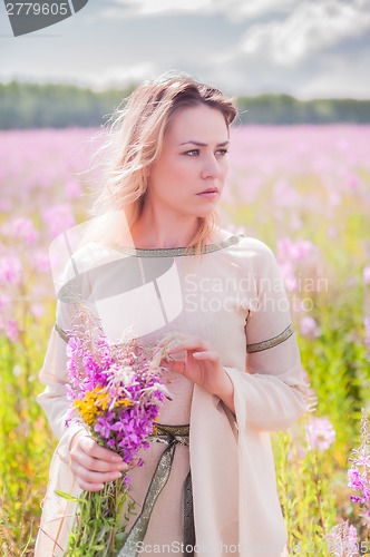Image of Beautiful sad girl on meadow