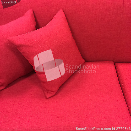 Image of Pink sofa with cushions