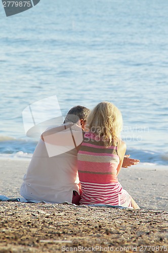 Image of mature couple on sand at beach