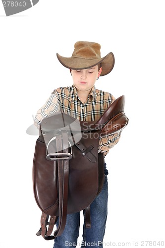 Image of Rural boy holding a saddle