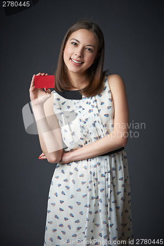 Image of Smiling female in dress with business card