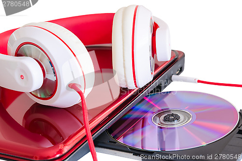 Image of Red headphones and laptop with compact disk