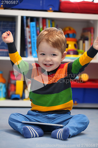 Image of Successful 2 years old boy winning using a digital tablet comput