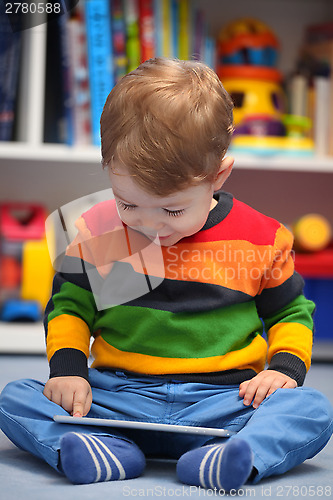 Image of Happy 2 years old boy using a digital tablet computer