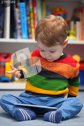 Image of Happy 2 years old boy using a digital tablet computer