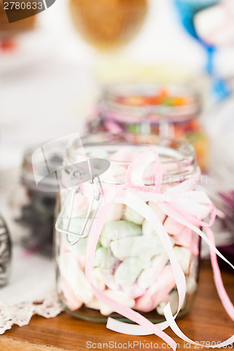 Image of Pastel colored marshmallows in jar