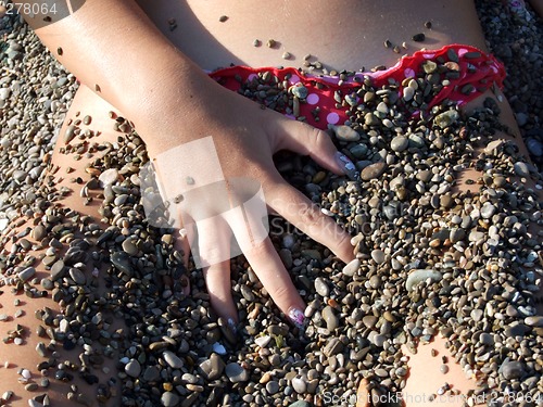 Image of The sexual girl in a pebble on a beach