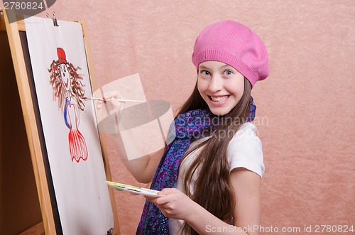 Image of Happy little girl draws a picture