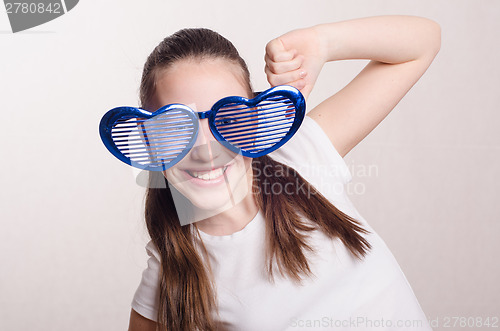 Image of Twelve year old girl with big glasses in shape heart