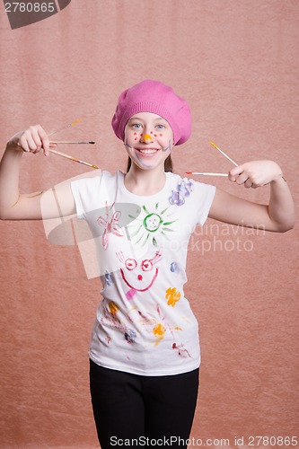 Image of Happy cheerful girl with a painted paint brushes