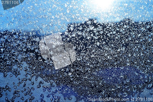 Image of Ice pattern and sunlight on winter glass