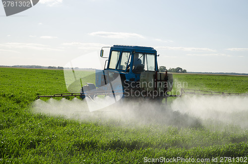 Image of Tractor fertilize field pesticide and insecticide 