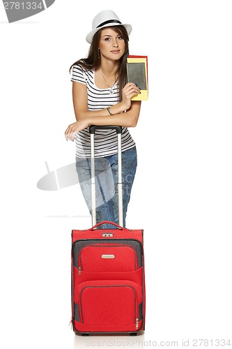 Image of Female in casual standing with travel suitcase
