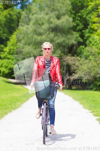 Image of Young woman riding a bicycle.