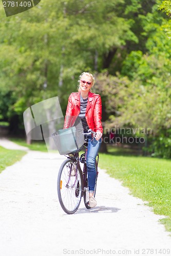 Image of Young woman riding a bicycle.