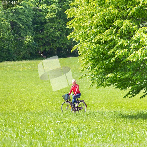 Image of Young woman riding a bicycle.