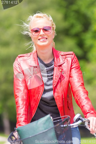 Image of Young woman riding a bicycle.