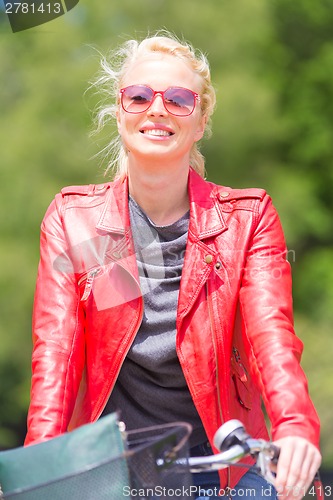 Image of Young woman riding a bicycle.