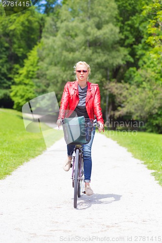 Image of Young woman riding a bicycle.