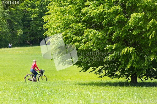 Image of Young woman riding a bicycle.