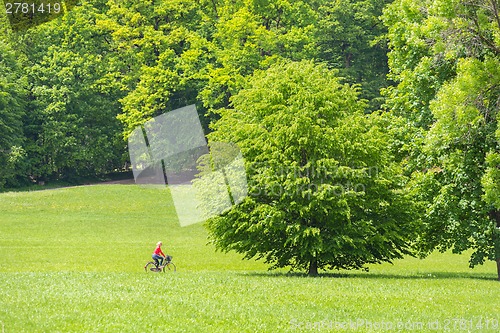 Image of Young woman riding a bicycle.