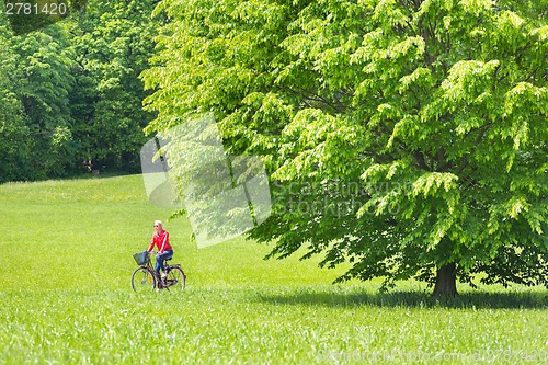 Image of Young woman riding a bicycle.