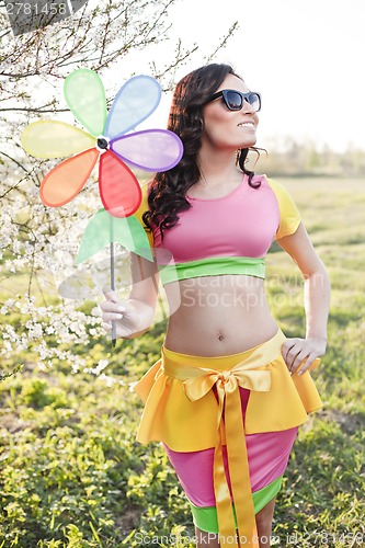 Image of Woman with toy turbine summer vacation