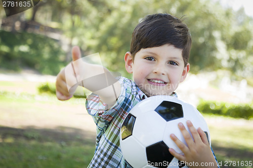 Image of Cute Young Boy Playing with Soccer Ball in Park
