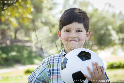 Image of Cute Young Boy Playing with Soccer Ball in Park