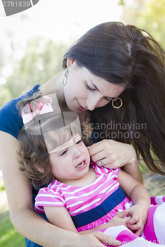 Image of Loving Mother Consoles Crying Baby Daughter