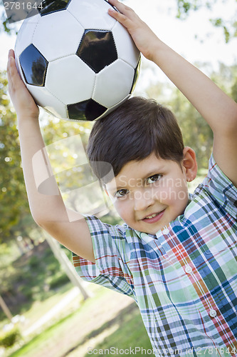 Image of Cute Young Boy Playing with Soccer Ball in Park