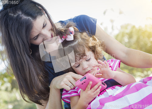 Image of Mother and Cute Baby Daughter Playing with Cell Phone