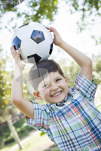 Image of Cute Young Boy Playing with Soccer Ball in Park
