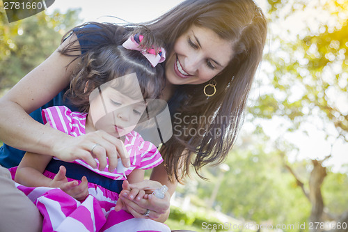 Image of Young Mother and Cute Baby Girl Applying Fingernail Polish