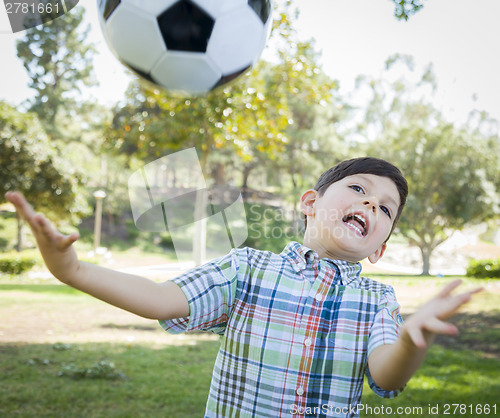 Image of Cute Young Boy Playing with Soccer Ball in Park